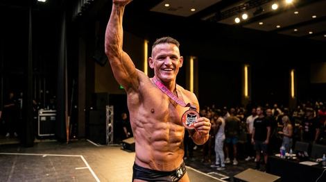Real NPC competition win moment, arm raised, crowd